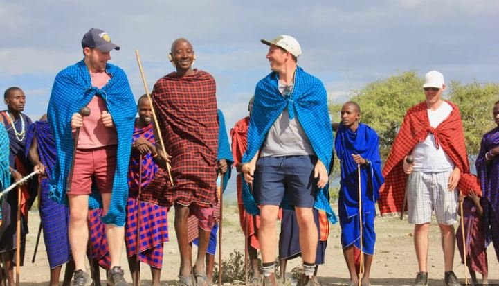 image of tourists with locals